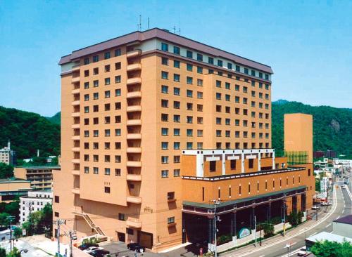 a tall building with a street in front of it at Jozankei Manseikaku Hotel Milione in Jozankei