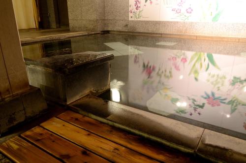 einen Pool mit Wasser in der Mitte eines Raumes in der Unterkunft Jozankei Manseikaku Hotel Milione in Jozankei