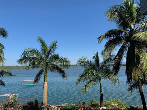 a view of a large body of water with palm trees at Blue Waters in Kundapur