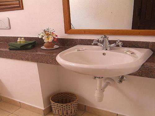 a white sink in a bathroom with a mirror at Pinewood Beach Resort and Spa in Diani Beach