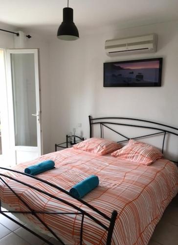 une chambre avec un lit avec des oreillers bleus dessus dans l'établissement VILLA EN CAMPAGNE POUR 8 PERS AVEC PISCINE PARC CLOTURE, à La Capelle-et-Masmolène