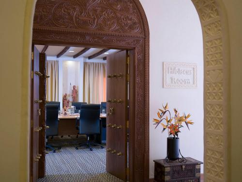 an open door to a meeting room with a table at Pinewood Beach Resort and Spa in Diani Beach