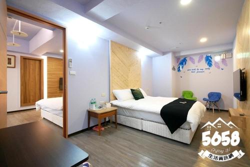 a hotel room with a bed and a television at Hotel Blessings in Kaohsiung