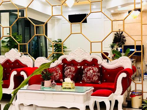 a living room with a red couch and a table at NEW CITY HOTEL in Tây Ninh