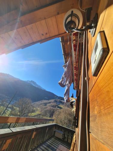 a view from the balcony of a house with a tv at Ferienhaus & Ferienwohnung Wiñay Wayna Gotschna Blick Klosters in Klosters Serneus