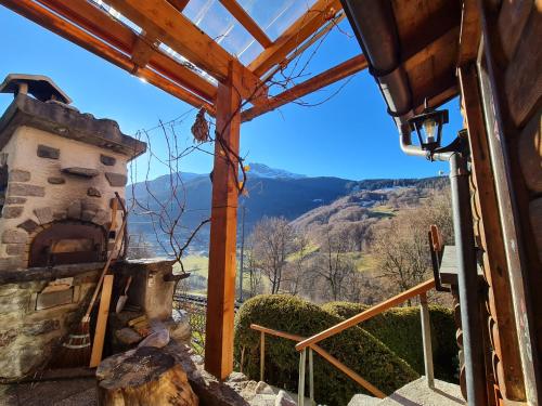 a view from the outside of a house with a stone oven at Ferienhaus & Ferienwohnung Wiñay Wayna Gotschna Blick Klosters in Klosters Serneus