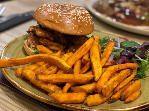 a plate with a hamburger and french fries on a table at JJs Lodge Lakewood in York