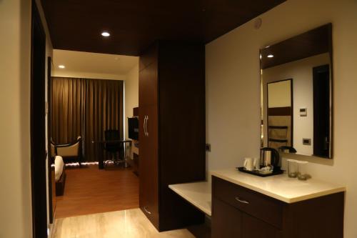 a bathroom with a sink and a mirror at Hotel Imperia Suites in Jalandhar