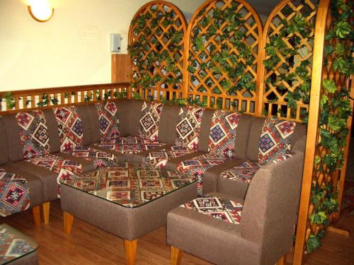 a living room with two couches and a table at Гостиница ИЛЕК in Aktobe