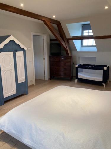 a bedroom with a large white bed and a dresser at House Zoute Stables 125sqm in 5 Ha property near seaside in Knokke in Knokke-Heist