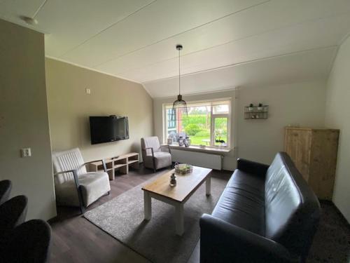a living room with a couch and a table at Bed and breakfast de Boerderij in Albergen