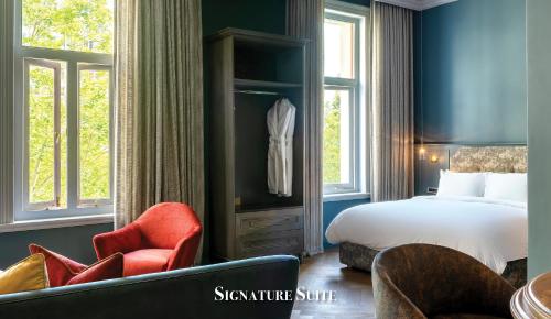 a hotel room with a bed and two chairs at Labotessa Luxury Boutique Hotel in Cape Town