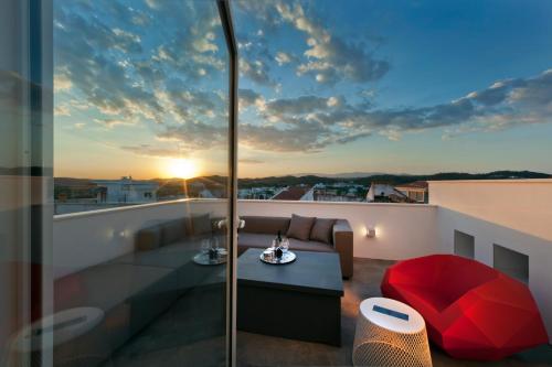 a balcony with a couch and a table on a roof at Casa Xonar in Silves