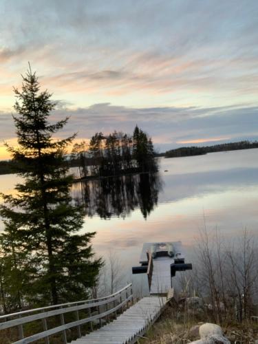 a boat tied up to a dock on a lake at VITA Ruokolahti 3 in Ruokolahti