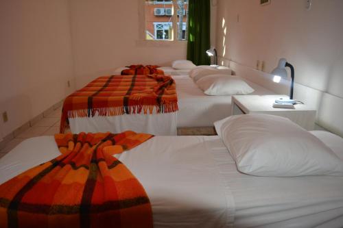 a group of four beds in a room at Capitania Praia Hotel Fazenda in Porto Seguro