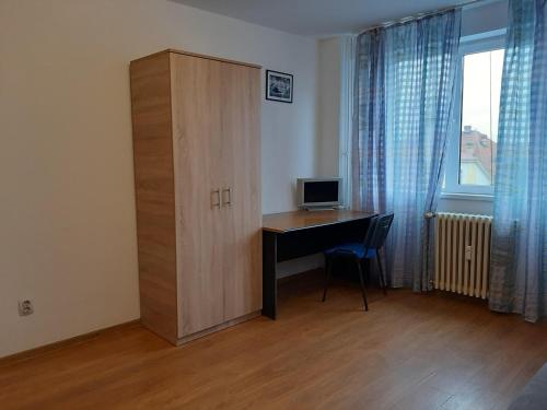 a room with a desk and a cabinet with a computer at Ultracentral apartment bulevard regele mihai nr 10, sc a ap 16 in Timişoara
