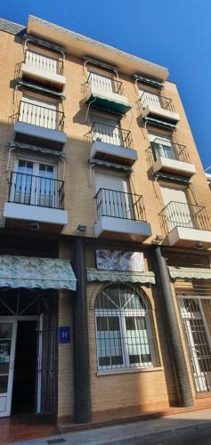 a tall building with balconies on the side of it at Hugo Beach Hotel & Apartments in Gandía