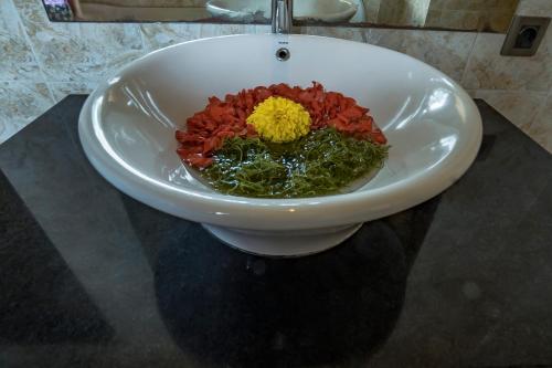 a bowl of food in a sink on a counter at Iman Homestay Ubud in Ubud