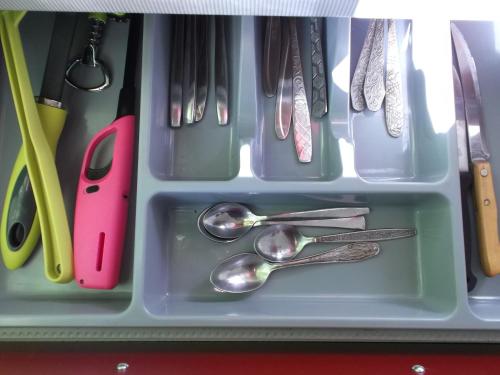a tray with spoons and utensils in a drawer at Hansa Apartment in Tallinn