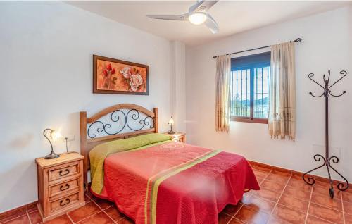 a bedroom with a red bed and a window at Cortijo Sylvestris in Periana