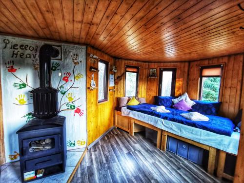 a room with two beds and a wood stove at Piece of Heaven and Piece of Dream in Râşnov