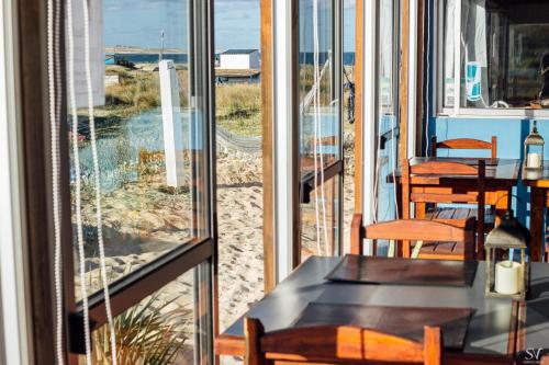 a room with a view of the beach through a window at Puertas al Cabo in Cabo Polonio
