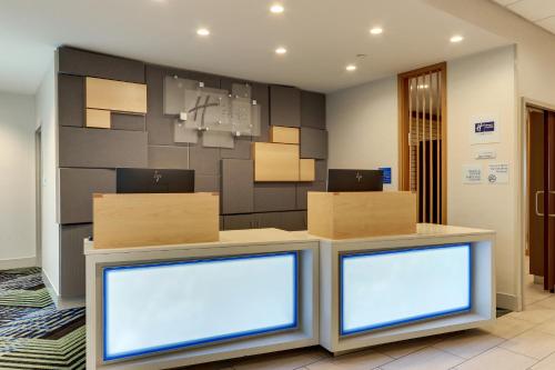a lobby with two monitors with boxes on top at Holiday Inn Express & Suites - Saugerties - Hudson Valley by IHG in Saugerties