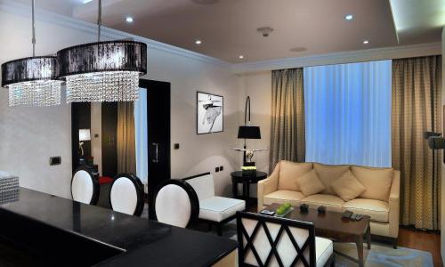 a living room with a couch and a table at Sun City Hotel - The Gabriel in Cairo
