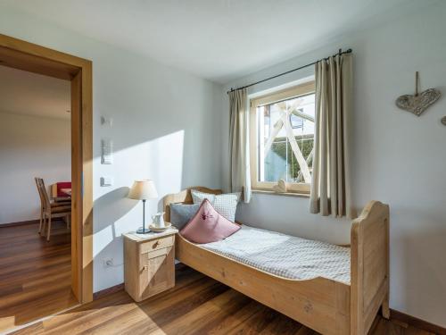 a bedroom with a bed and a window at Appartement Holaus in Westendorf