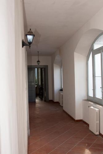 an empty hallway in a house with a window at Palazzo D'Orsi in Calvanico