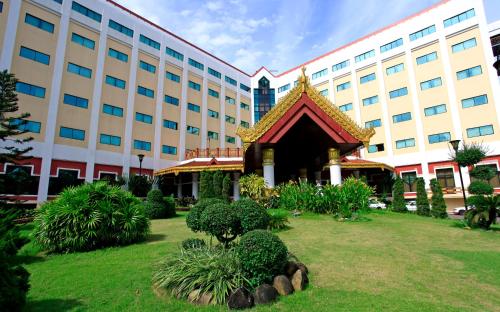 a building with a garden in front of a building at Summit Parkview Yangon in Yangon