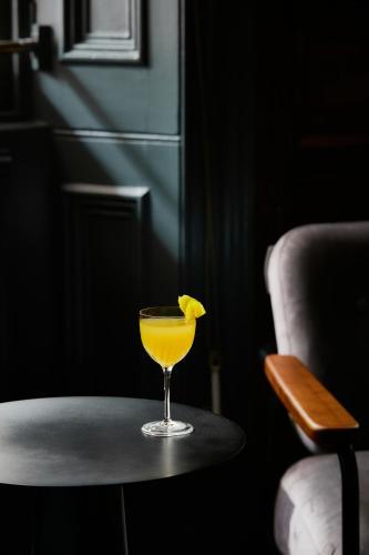 a glass of orange juice sitting on a table at The Columbia in London