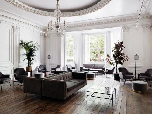 a large living room with a couch and chairs at The Columbia in London
