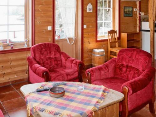 a living room with two chairs and a table at 6 person holiday home in HOSTELAND in Hosteland