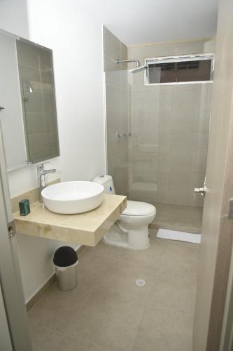 a bathroom with a sink and a toilet and a shower at OR HOTEL 94 in Barranquilla