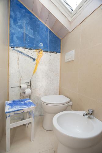 a bathroom with a toilet and a sink at Palazzo delle Biscie - Old Tower & Village in Molinella