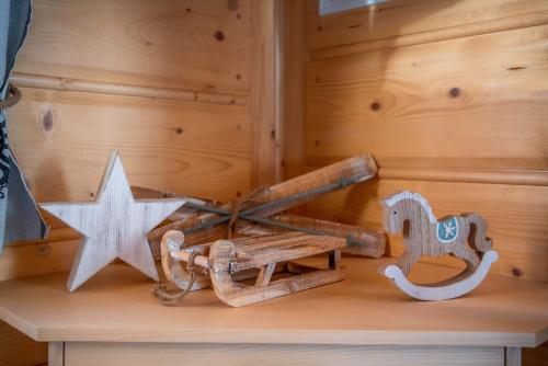 a wooden cart and a star on a table at Domki Widokowe Wooden Luxury Chalet with Private Jacuzzi in Ząb