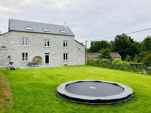 a house with a large yard with a trampoline at Classy Holiday Home in Achet with Garden 