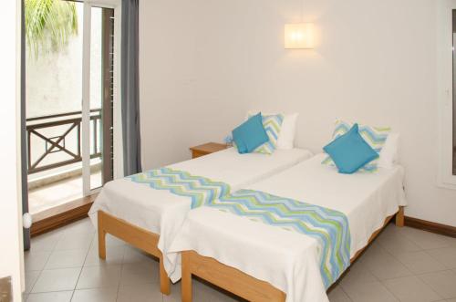 a bedroom with two beds and a large window at Exclusive penthouse with paradise sea view in Grand-Baie