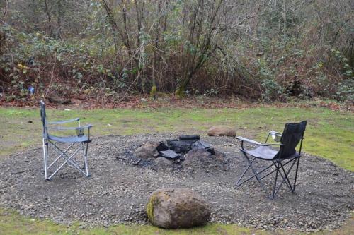 two chairs and a fire pit in a yard at Newly built Modern Chalet Duplex - 2 in Mount Hood Village