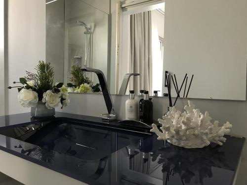 a bathroom counter with a sink and a mirror at Levante Holiday Apartments in Larnaca