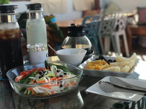 a table topped with a salad and a bowl of food at Na Jie 17 in Donghe