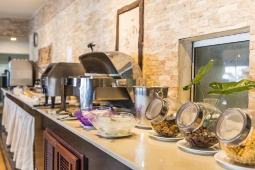 a kitchen counter with bowls of food on it at The L Resort, Krabi in Ao Nang Beach