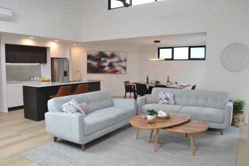 a living room with a couch and a table at The Tipsy Grape Downtown, Margaret River in Margaret River Town