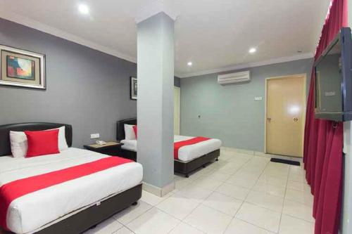 Postel nebo postele na pokoji v ubytování Puteri Ampang Hotel