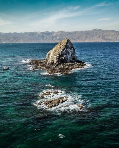a large rock in the middle of the ocean at Radisson Blu Resort, Fujairah in Dibba