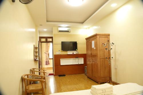 a living room with a table and a tv in a room at Duong Ha Hotel in Cao Bằng