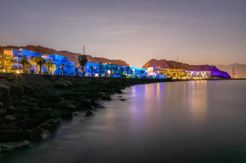 a view of a body of water at night at Radisson Blu Resort, Fujairah in Dibba