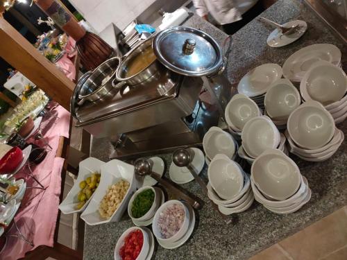 a kitchen counter with plates and bowls of food at Happy Life Village Dahab in Dahab