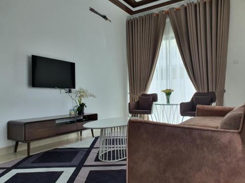 a living room with a couch and a tv at Homestay D'Bertam, Kepala Batas, Penang, Muslim Saja in Kepala Batas